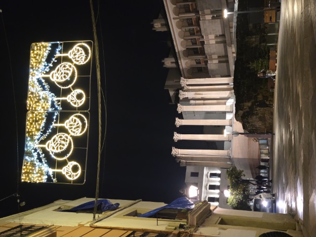 Roman Temple of Córdoba Spain with ancient Corinthian columns lit up at night under decorative Christmas lights