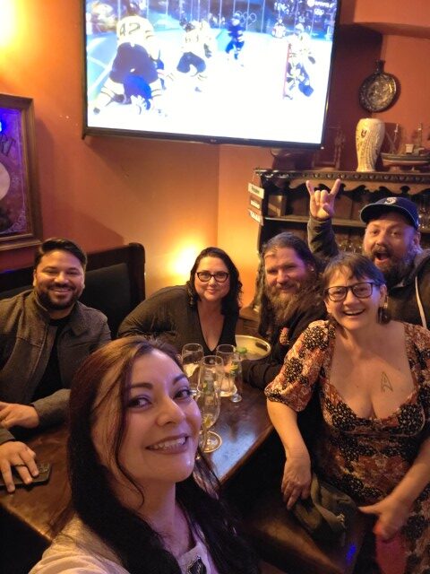 Group of friends taking a selfie at a bar watching hockey in Portugal