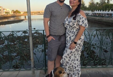Couple and their beagle posing on the Roman Bridge in Tavira Portugal at sunset