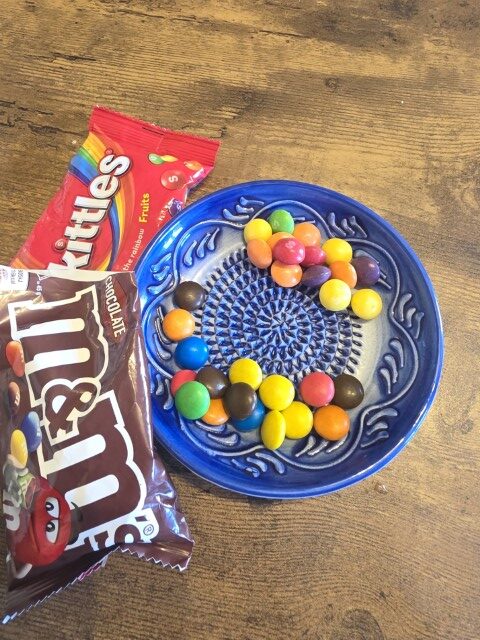 M&M's and Skittles candy in a Portuguese dish. 